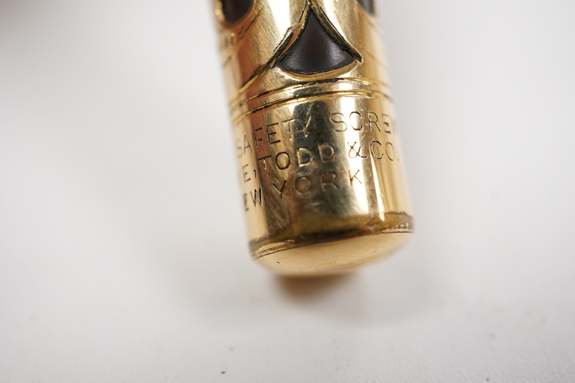 A Swan MT & Co. sterling silver filigree eyedropper along with similar gold filled example
